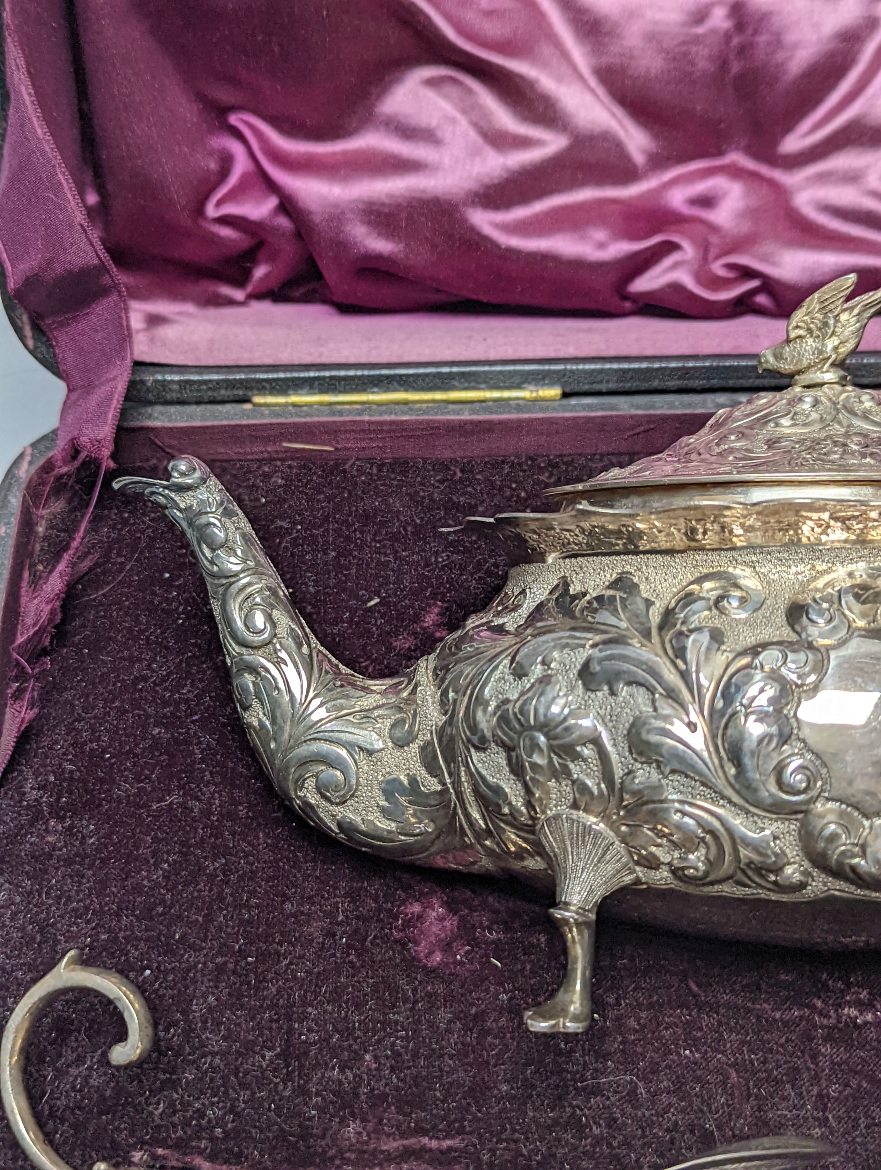 A cased late Victorian Scottish repousse silver three piece tea set, Hamilton & Inches, Edinburgh, 1897, gross 21.5oz.
